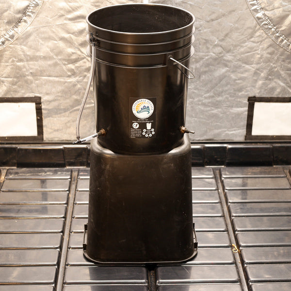 Black plastic bin with a label on a metal surface