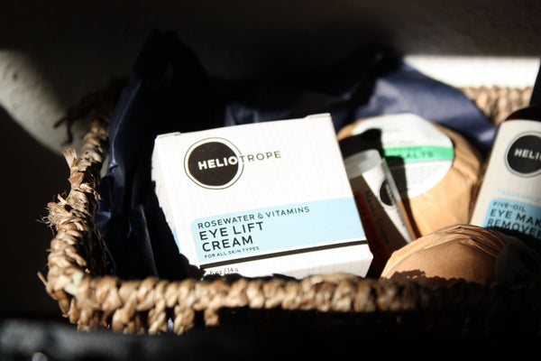 Heliotrope SF rosewater eye cream and natural skincare products arranged in a woven basket