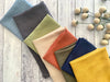 Close-up of a cotton crinkle cloth napkin laid flat on a table showing fabric detail