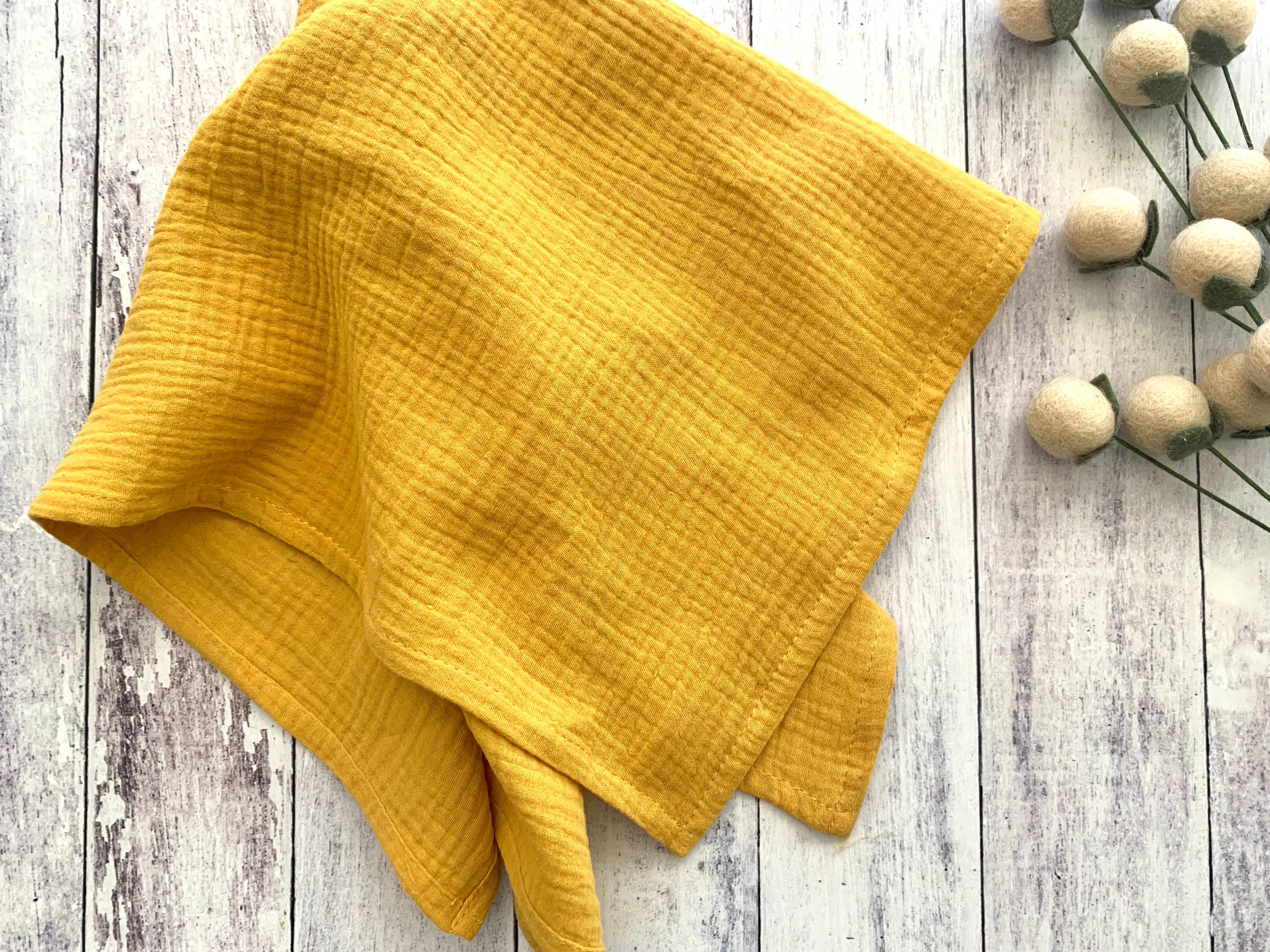 Yellow fabric on a wooden surface with decorative elements