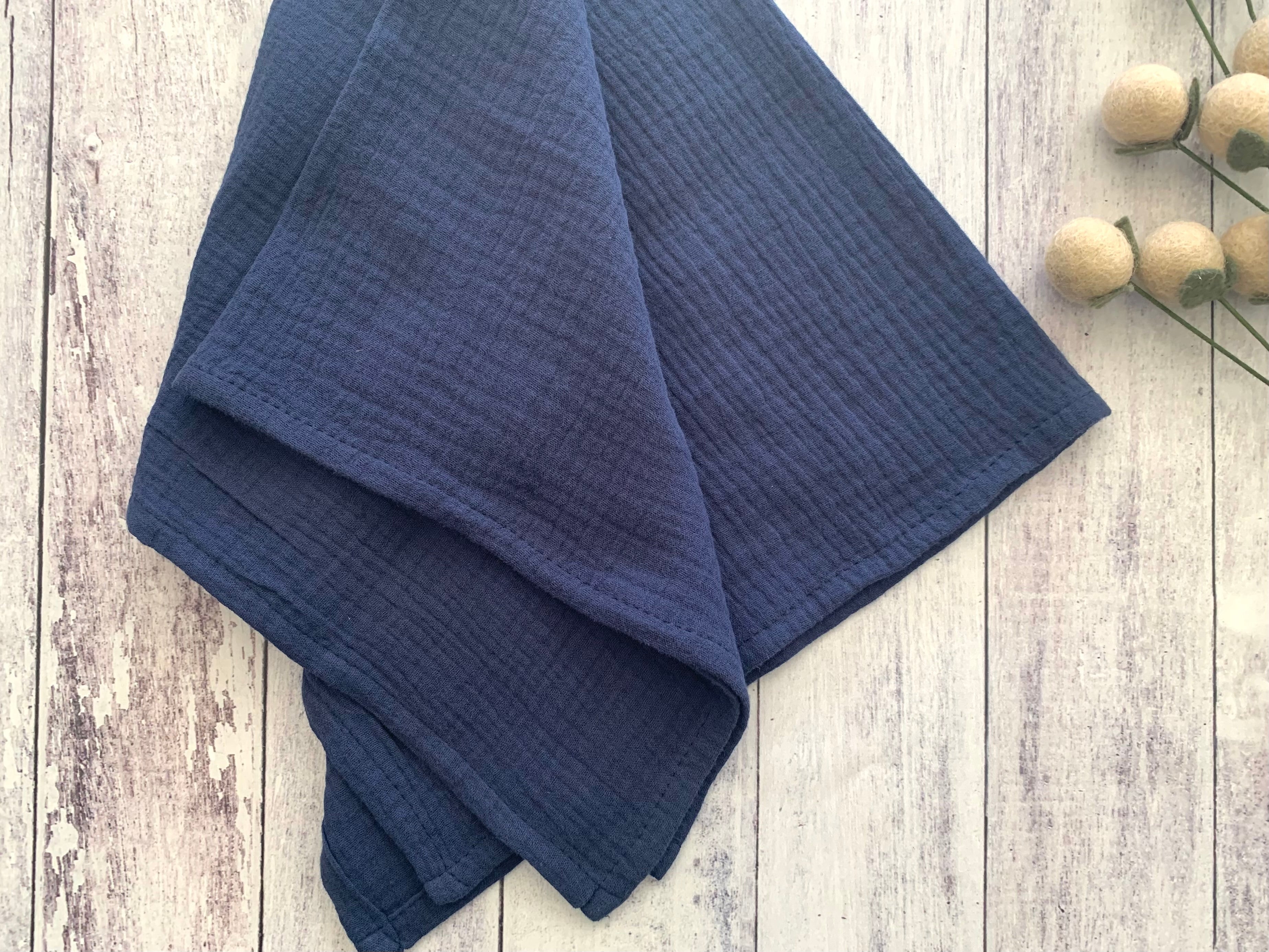Blue fabric on a wooden surface with a minimal background