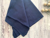 Blue fabric on a wooden surface with a minimal background