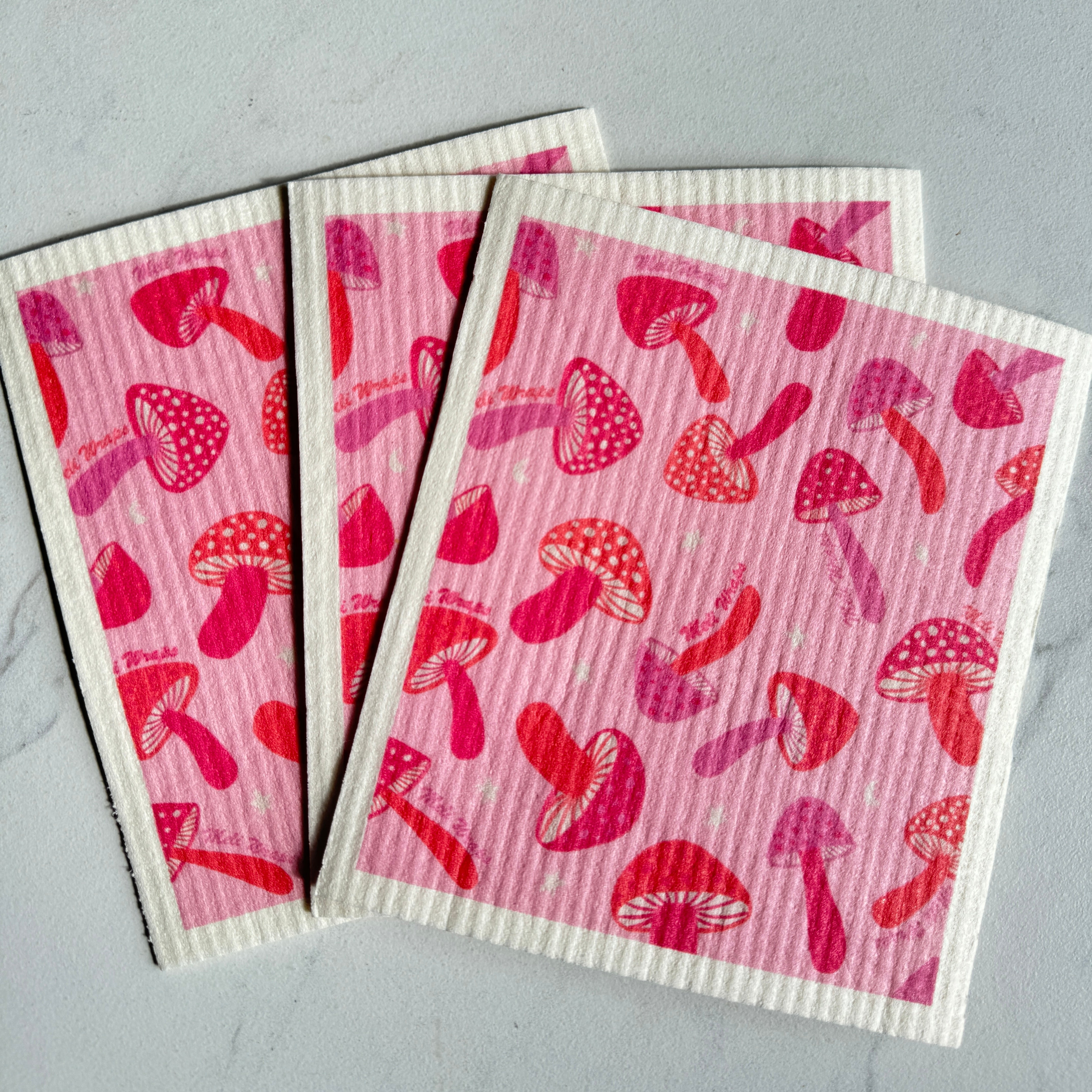 Pink Mushroom Swedish Dish Cloth being used to wipe a smooth surface
