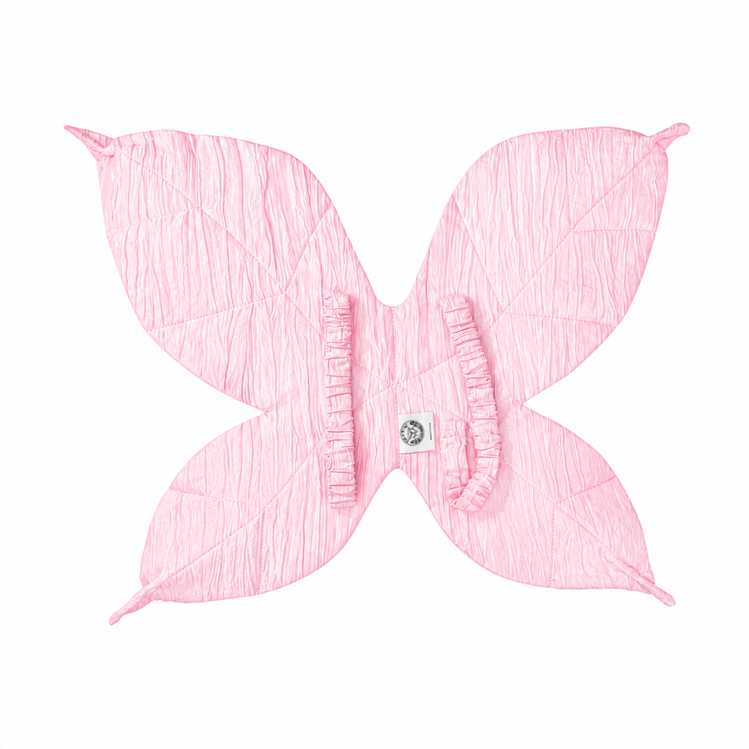 Pink fairy wings worn during imaginative dress-up play