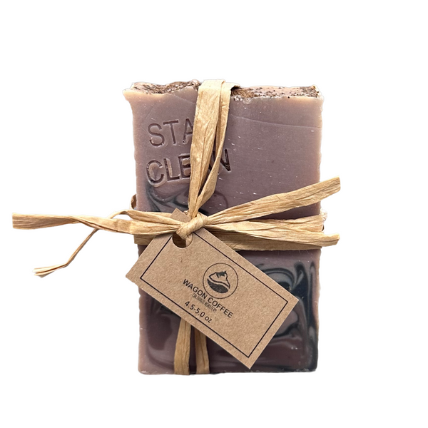 Stay Clean Coffee Soap bar stamped with 'Stay Clean' message, topped with Papua New Guinea coffee beans, by Wagon Coffee