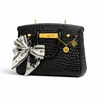 Onali Pure Black Large Iconic luxury bag-shaped candle on a styled surface, bold black silhouette with warm fragrance