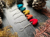 Rainbow wool heart ornaments from the five-piece set displayed together