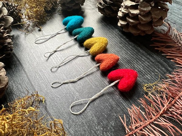 Rainbow wool heart ornaments from the five-piece set displayed together
