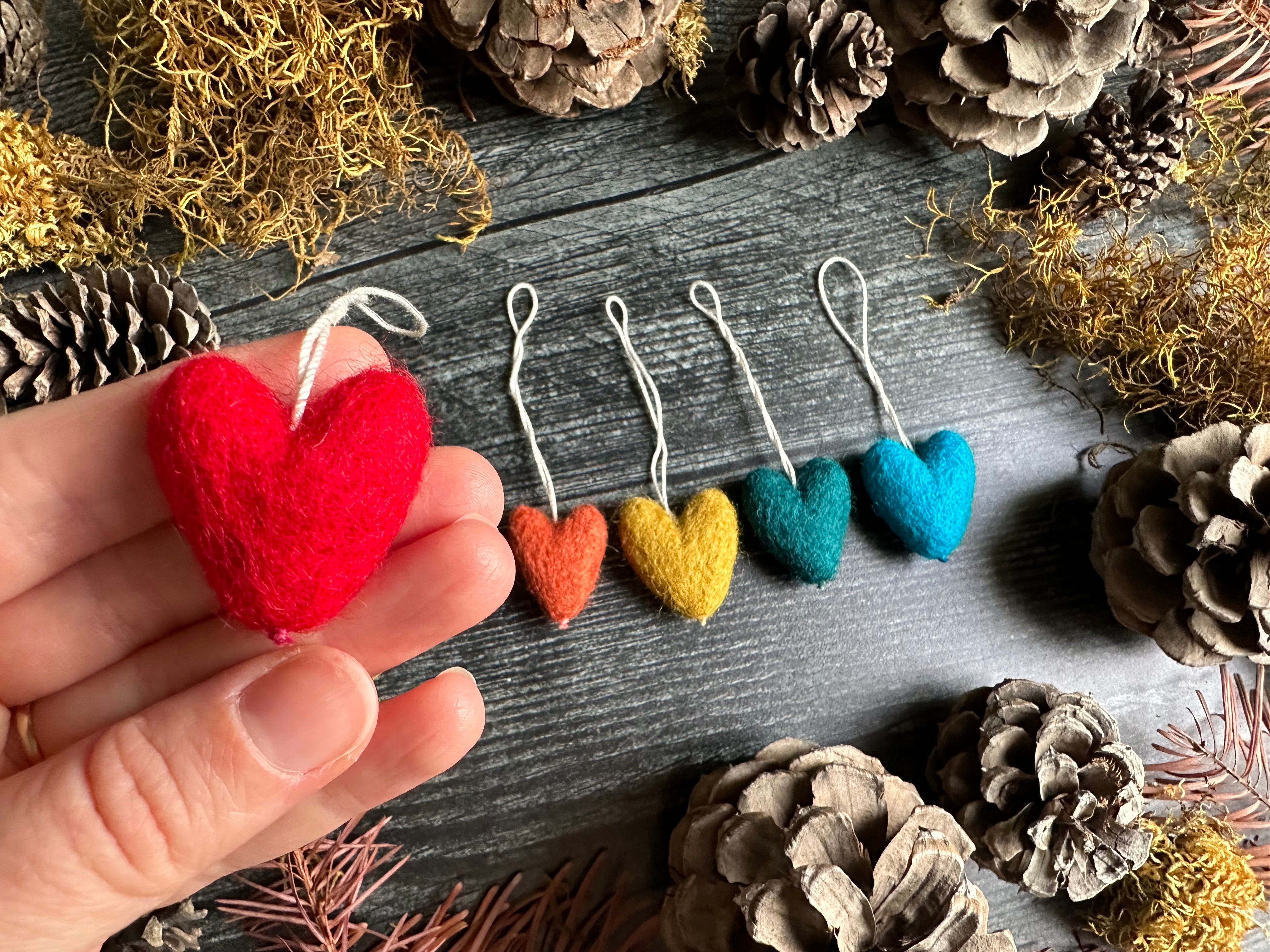 Needle-felted wool heart ornament with cotton string loop, close view