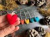 Needle-felted wool heart ornament with cotton string loop, close view