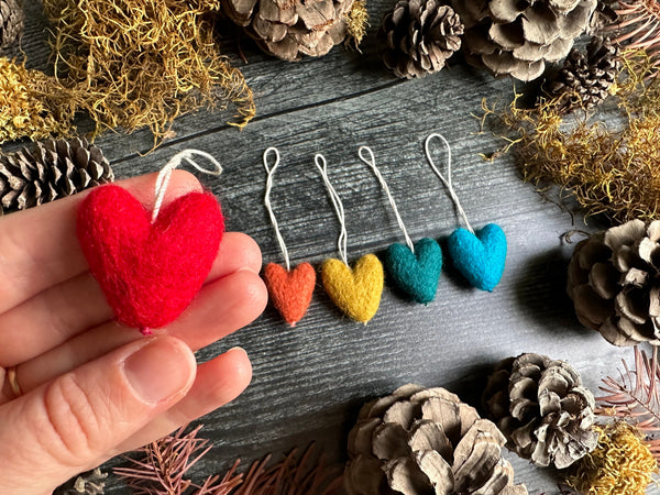 Needle-felted wool heart ornament with cotton string loop, close view