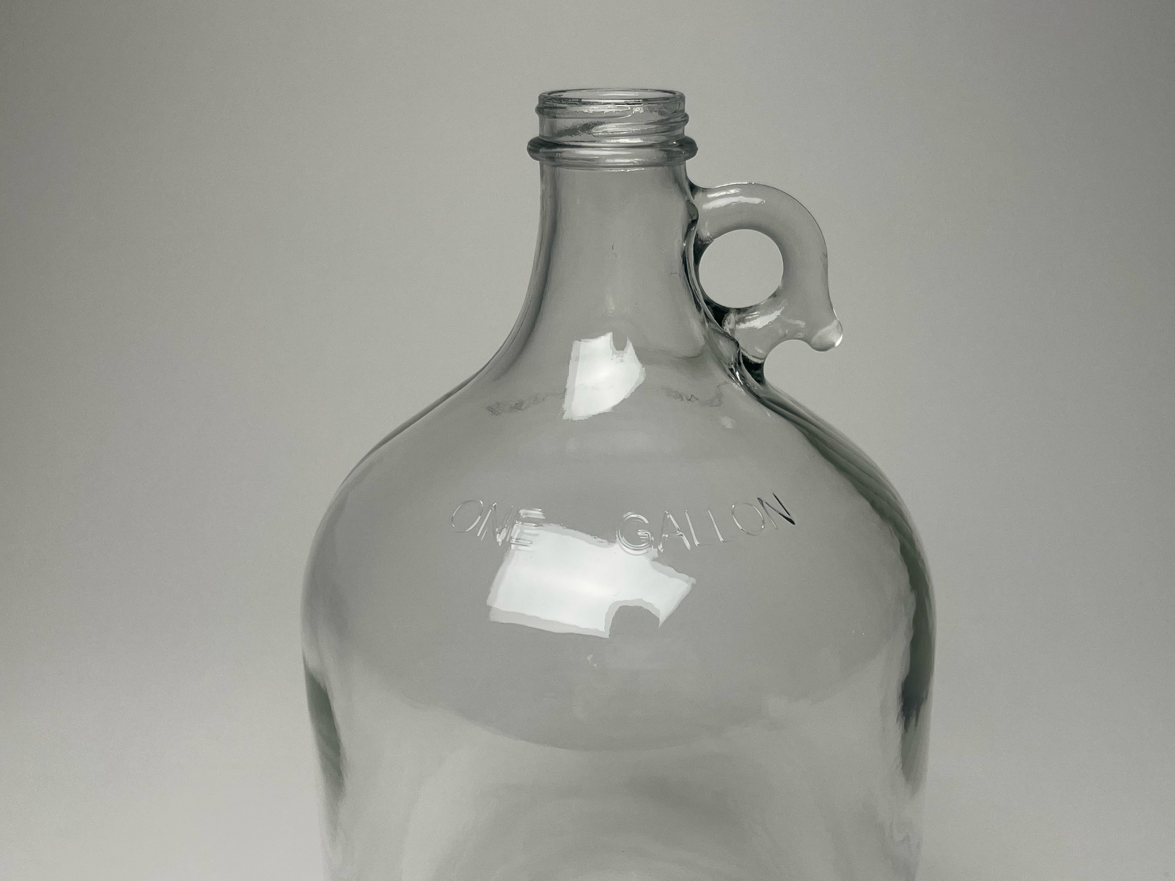 Rustic Strength 1 gallon glass jug showing full body and secure screw-top cap