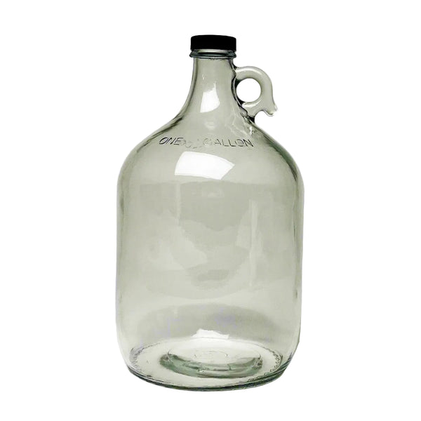 Rustic Strength 1 gallon glass jug with screw cap on a wooden surface