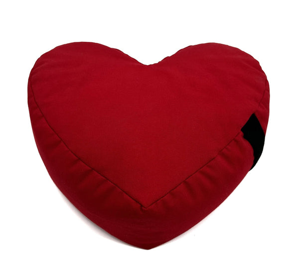 Red heart-shaped pillow on a white background