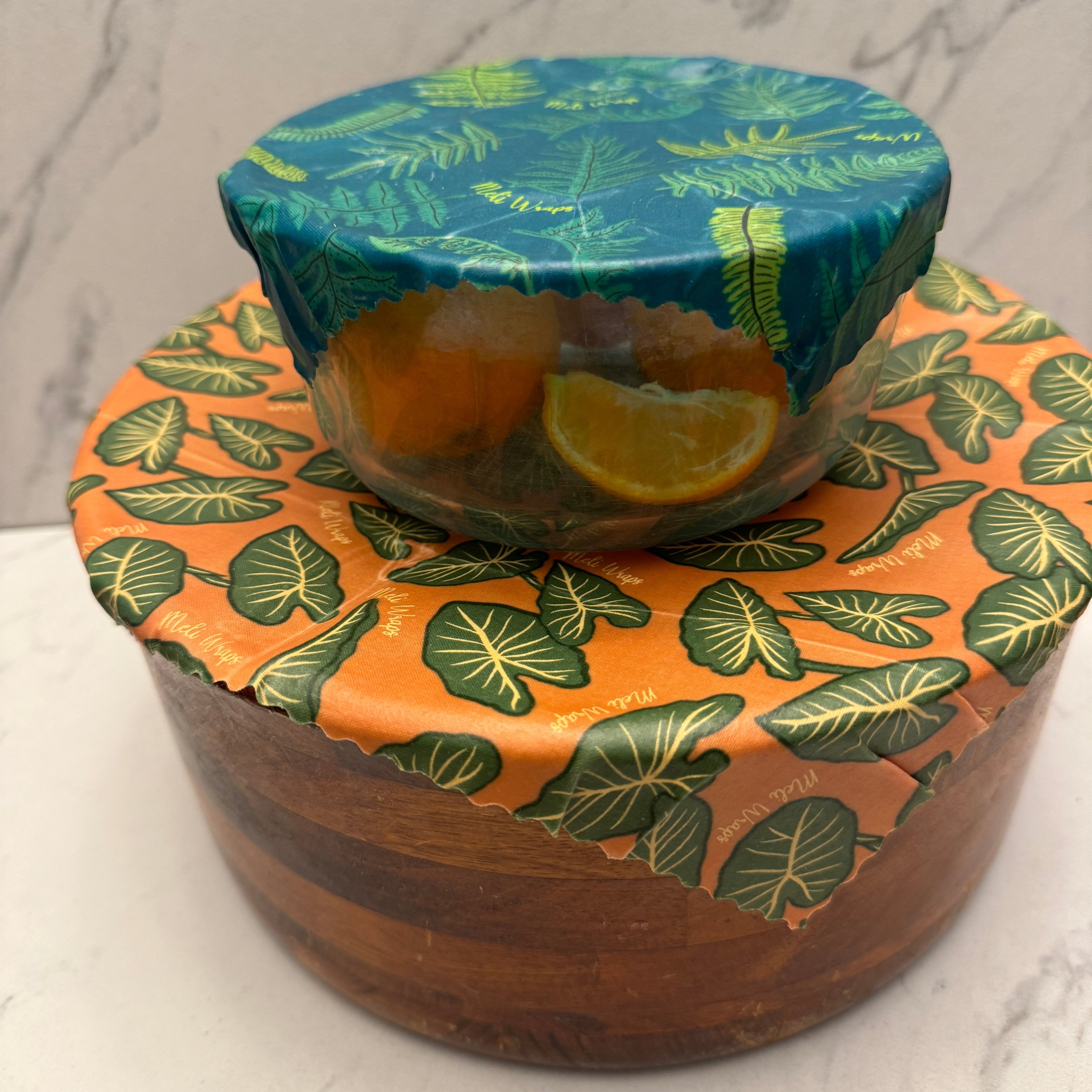 Meli Wraps Beeswax Food Wrap in Kalo Print folded into an envelope shape