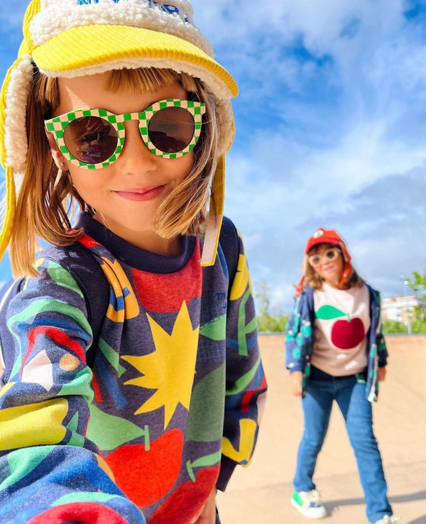 Child wearing Mon Coeur navy pattern sweatshirt with relaxed fit and dropped shoulders