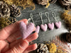 Close view of Anemone Purple wool heart ornaments with cotton string loops