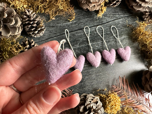 Close view of Anemone Purple wool heart ornaments with cotton string loops