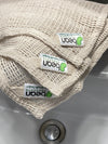 Beige washcloth with 'peaon' labels on a sink