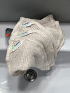 Beige mesh scrubber with 'bear' branding on a sink