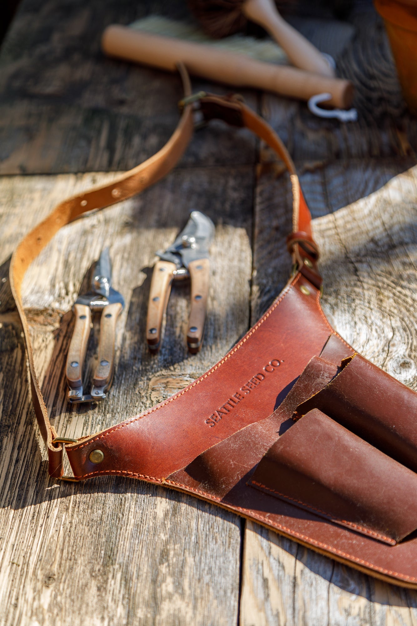 Close-up of Harvest Essentials leather tool belt showing handcrafted stitching and pocket detail