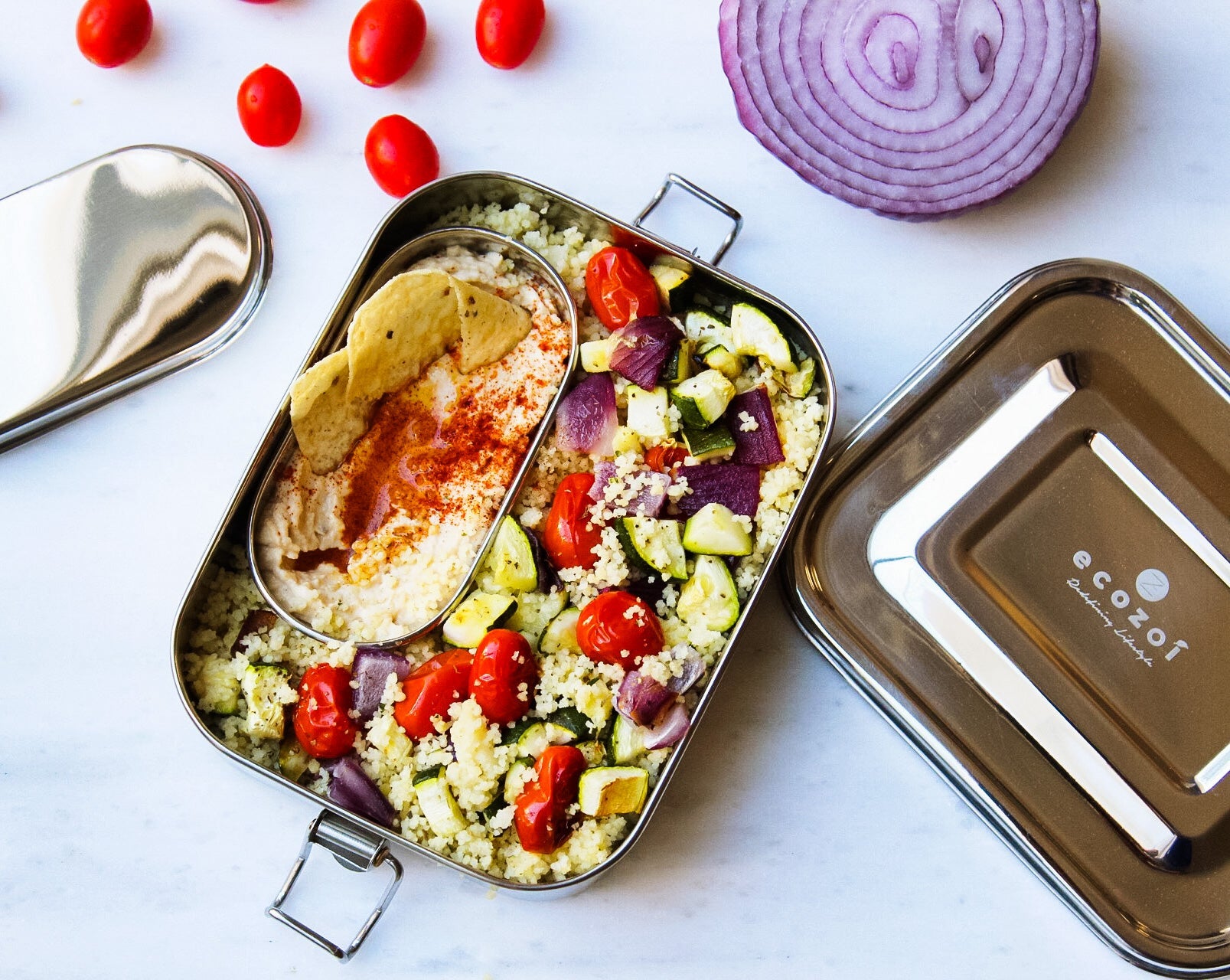 Ecozoi plastic-free stainless steel lunch box filled with a fresh meal, top-down view