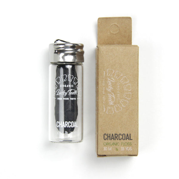 Charcoal toothbrush and packaging on a white background