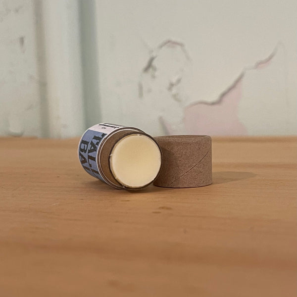 Close-up of grass-fed beef tallow lip balm handcrafted with organic beeswax and essential oils by Apotheke DuJardin