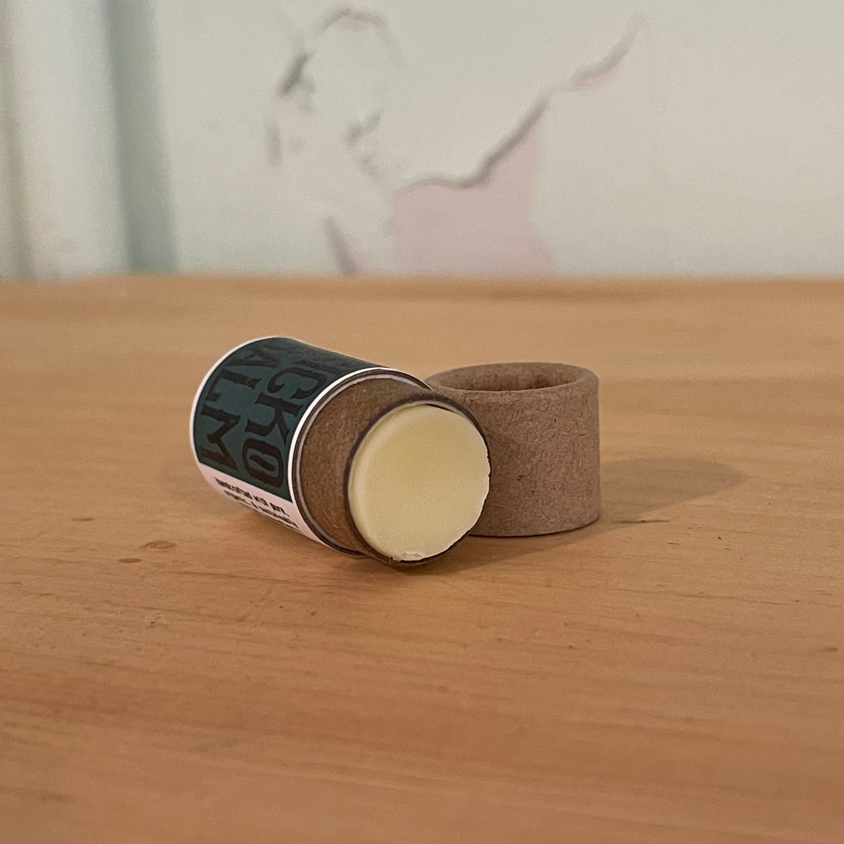 Close-up of Sicko Balm push-up lip balm tube showing organic herbal ingredients for cold sore and skin healing