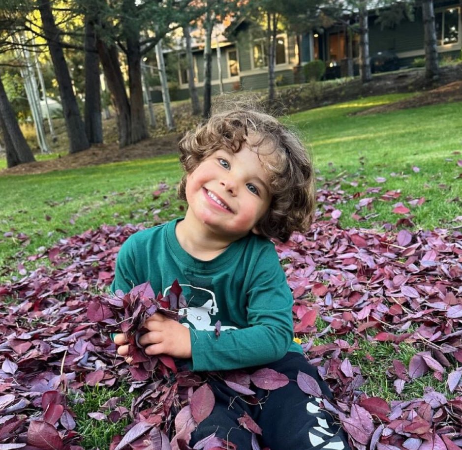 Baby wearing Mon Coeur Walter recycled cotton long-sleeve t-shirt in pine green — sustainable baby clothing by Mon Coeur