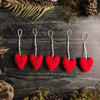 Set of five Amanita Red needle-felted wool heart ornaments with cotton string loops