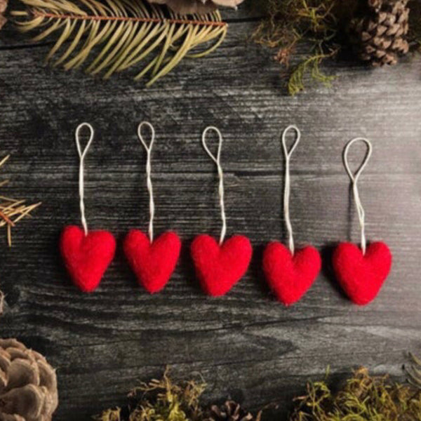 Set of five Amanita Red needle-felted wool heart ornaments with cotton string loops