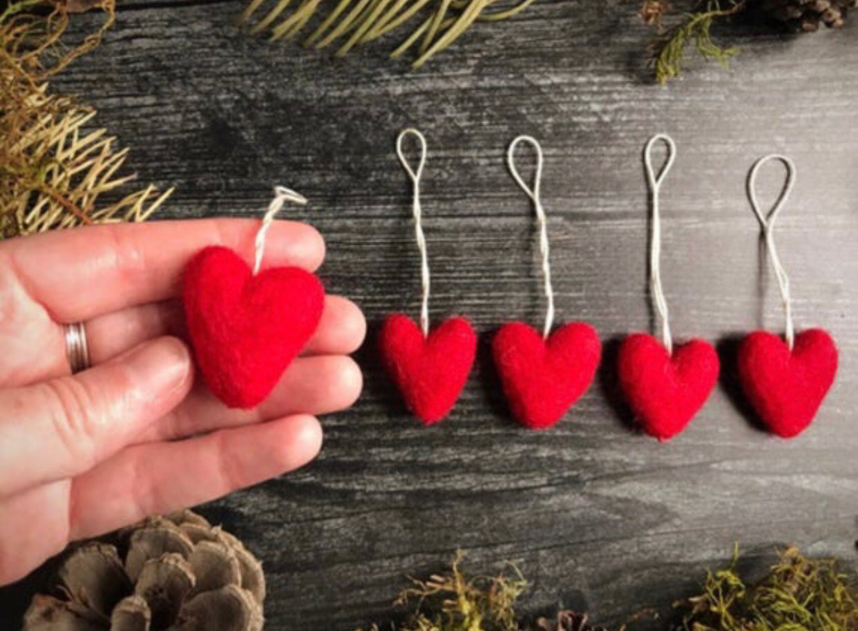 Add a touch of warmth and whimsy to your holiday decor with our set of 5 hand-felted wool heart ornaments. These eco-friendly and handmade ornaments are perfect for Christmas trees, wreaths, or as gift tags.