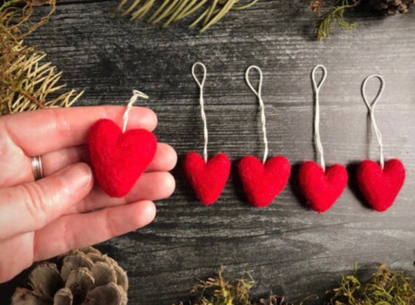 Close view of Amanita Red wool heart ornaments from House of Moss