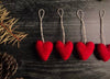 Needle-felted wool heart ornament in Amanita Red with cotton string hanger