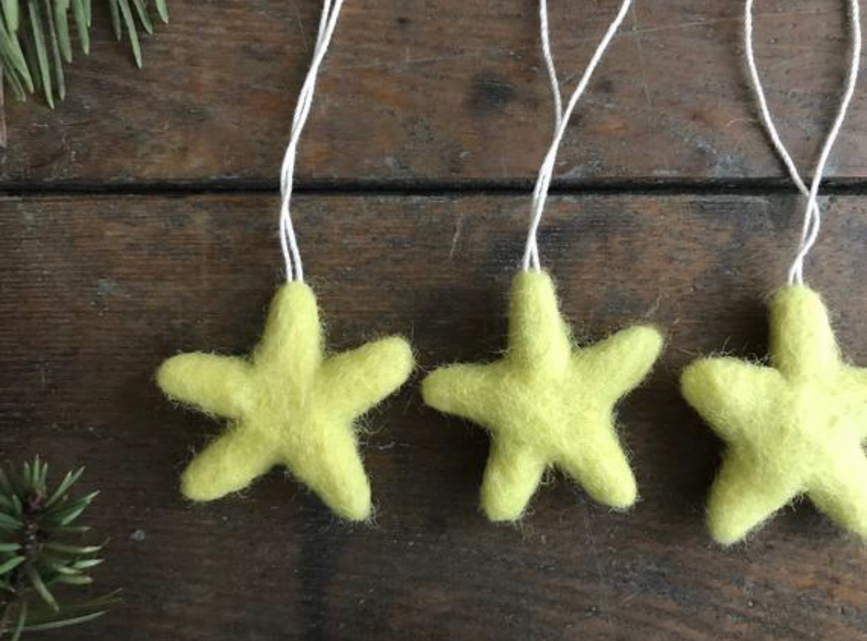 Needle-felted wool star ornament in Mahonia Yellow, detail of the felted texture
