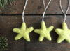 Needle-felted wool star ornament in Mahonia Yellow, detail of the felted texture