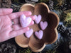 Close-up of needle-felted wool hearts in Mallow Pink