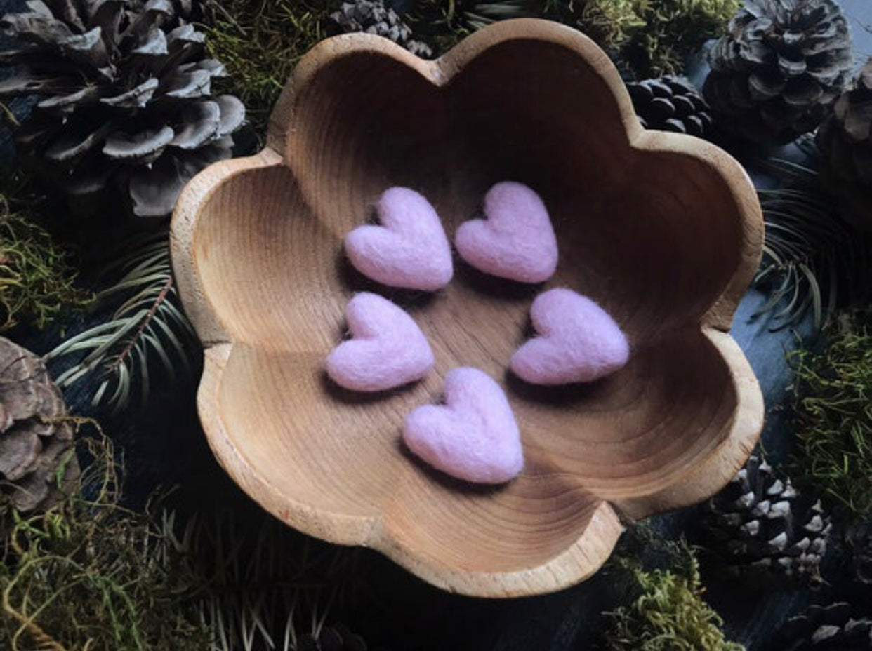 Five small felted wool hearts in Mallow Pink, each about 1 inch across
