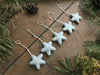 Five House of Moss wool star ornaments in Morning Blue, ready to hang