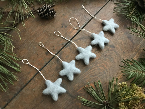 Five House of Moss wool star ornaments in Morning Blue, ready to hang