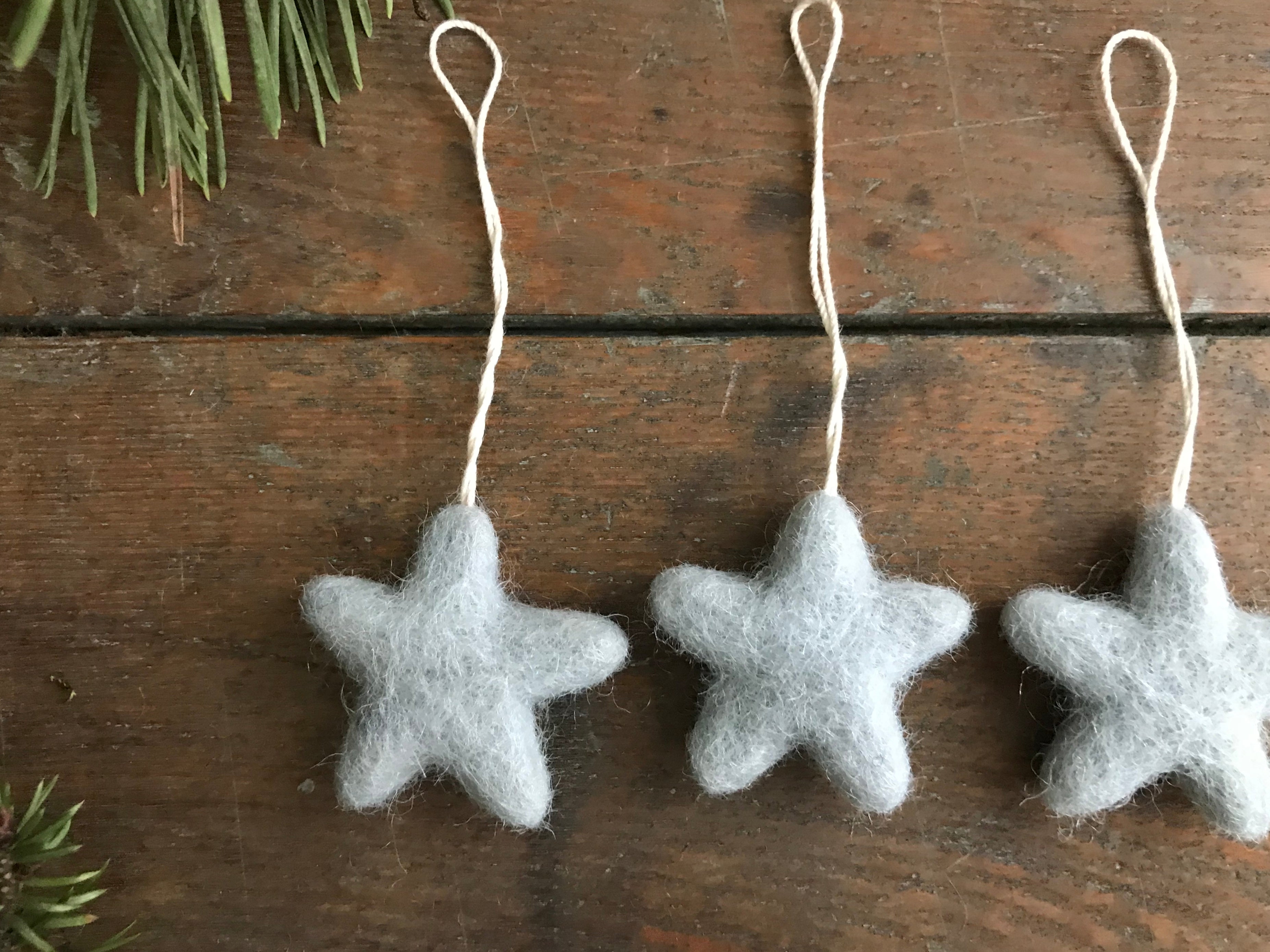 Close view of a needle-felted Morning Blue wool star ornament