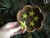 Close view of needle-felted wool stars in Mahonia Yellow