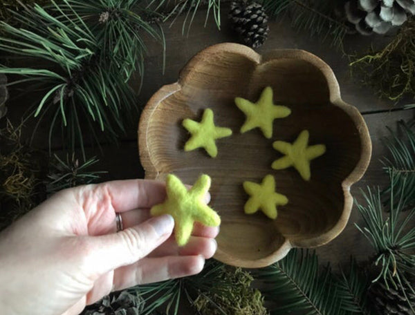 Close view of needle-felted wool stars in Mahonia Yellow