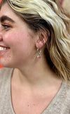 Close-up of Fair Anita Charm Dangle Hoops showing freshwater pearl detail and silver-plated finish
