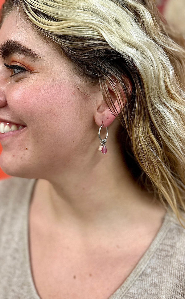 Close-up of Fair Anita Charm Dangle Hoops showing freshwater pearl detail and silver-plated finish