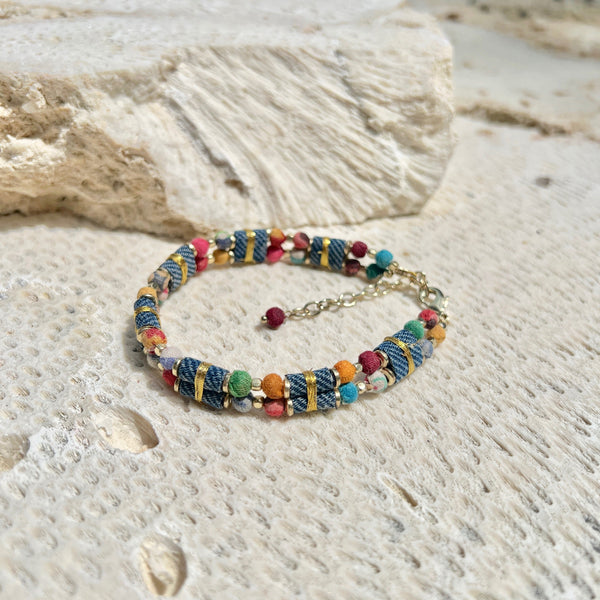 Colorful beaded bracelet on a textured stone surface