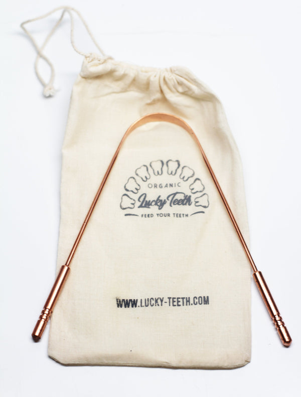Copper straws in a Lucky Teeth branded drawstring bag on a white background