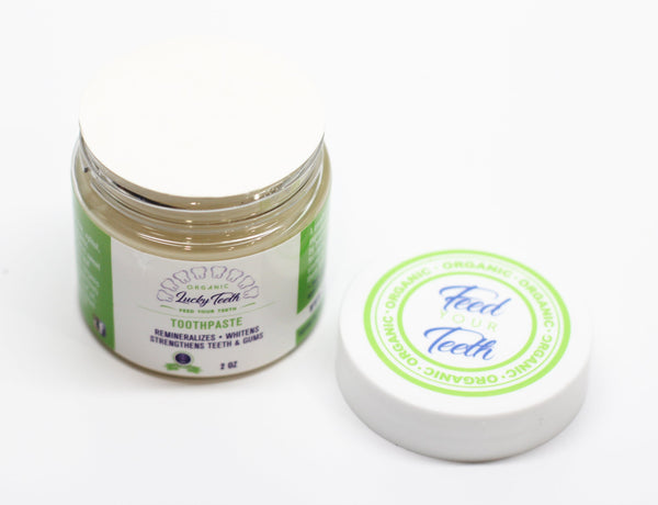 Jar of Lucky Teeth toothpaste with a white background