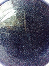 Close-up of a dark, textured surface with a triangular cutout